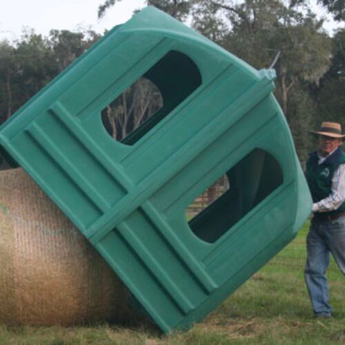Green hay hut used for storing hay being held aloft by an old farmer.