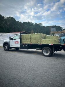 Truck full of winter hay available at J & J Hay Farm's feed store called Cherokee Feed.
